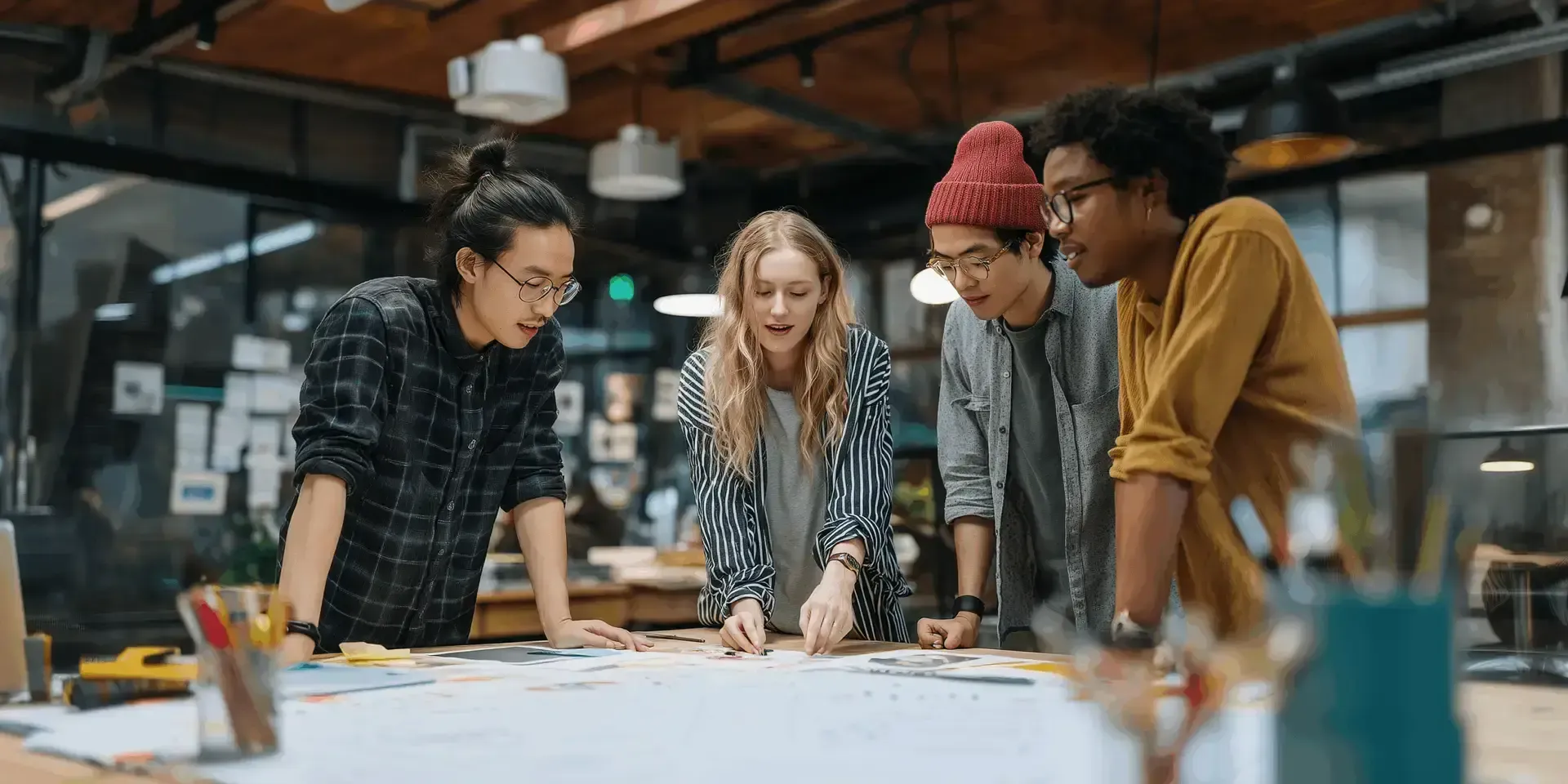 Colleagues discussing work around a desk