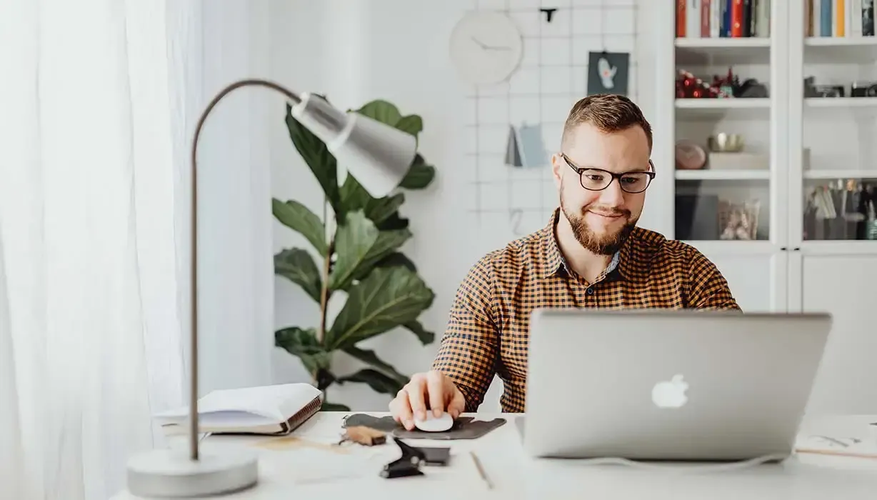 A contract professional working at a laptop